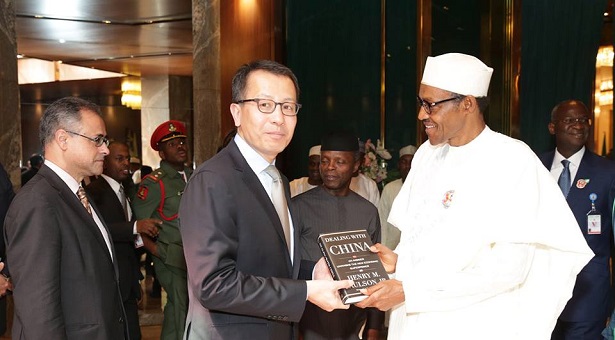 buhari ifc 2 - THEWILL NEWS MEDIA (R) President Muhammadu Buhari being presented with a book from the Executive Vice President and CEO, Mr Jin-Yong Cai (L) after a meeting with the IFC Team, at the State house.