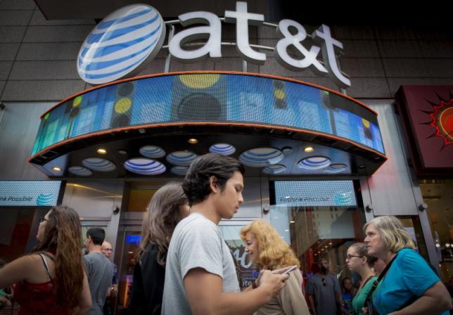 People walk past the AT&T store in New York's Times Square