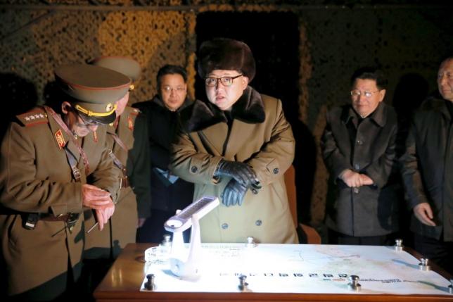 KCNA picture shows North Korean leader Kim Jong Un talking with officials at the ballistic rocket launch drill of the Strategic Force of the Korean People's Army at an unknown location