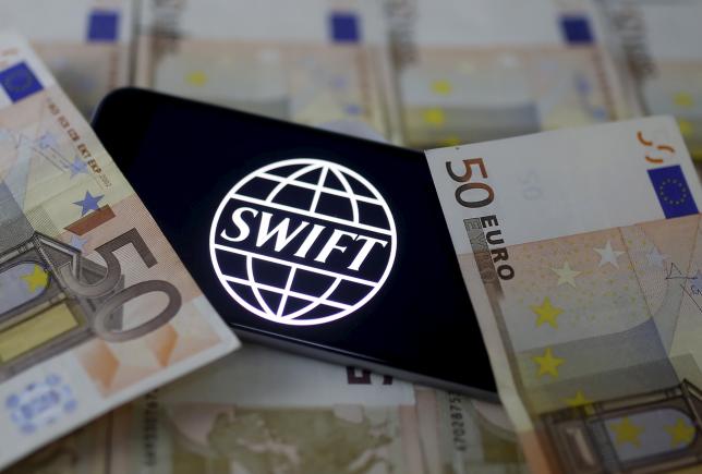Swift code bank logo is displayed on an iPhone 6s on top of Euro banknotes in this picture illustration made in Zenica