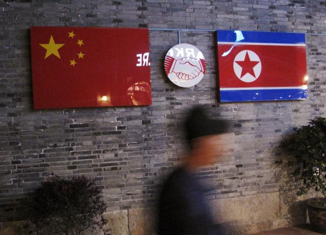 Flags of China and North Korea are seen outside the closed Ryugyong Korean Restaurant in Ningbo
