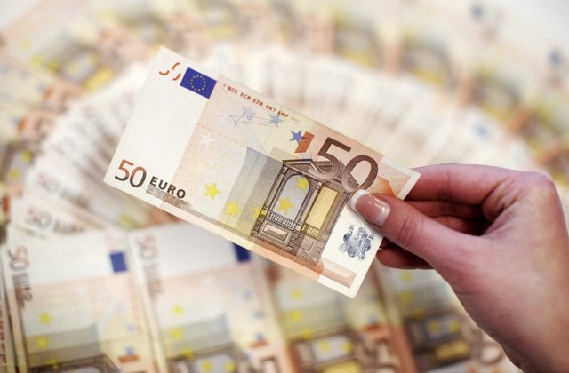 An employee shows fifty-euro notes in a bank in Sarajevo