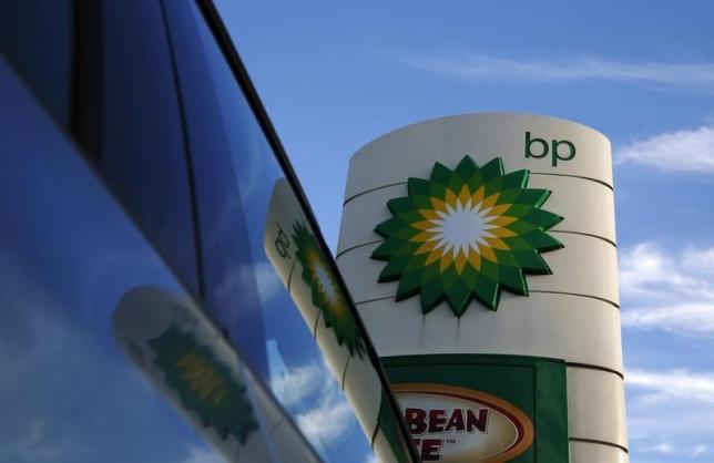 A BP logo is reflected in a car window at a petrol station in London