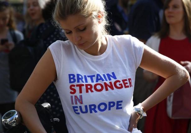 A woman wearing a vote remain tee-shirt reacts, following the result of the EU referendum, in London