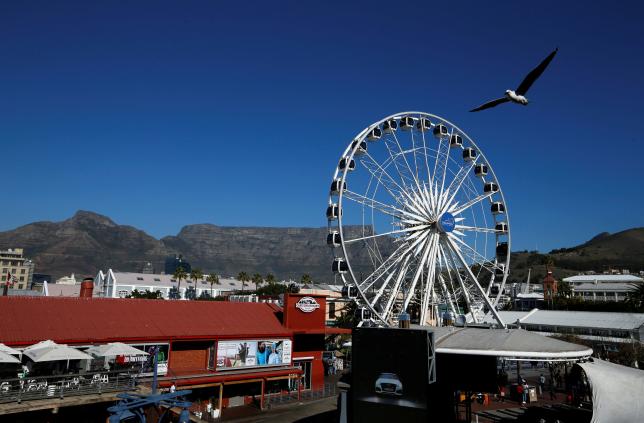 The iconic Table Mountain is seen behind a popular tourist destination in Cape Town