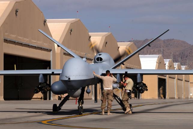 U.S. airmen prepare a U.S. Air Force MQ-9 Reaper drone as it leaves on a mission at Kandahar Air Field