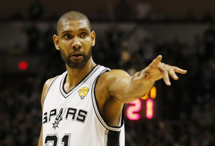 Spurs' Duncan points to the bench during a break in play against the Heat during Game 3 of their NBA Finals basketball playoff in San Antonio