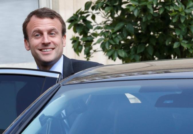 French Economy Minister Emmanuel Macron leaves the Elysee Palace in Paris