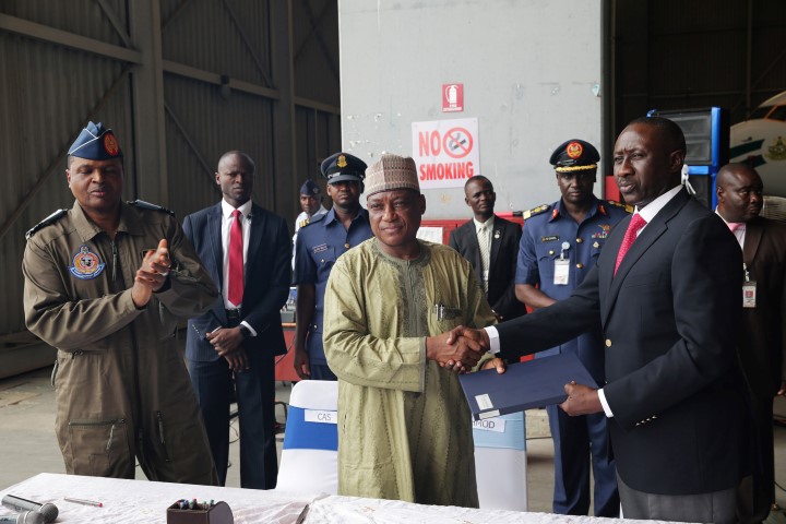 TWO PRESIDETIAL HELICOPTERS DONATED TO AIRFORCE - THEWILL NEWS MEDIA FGN DONATES TWO PRESIDENTIAL HELICOPTERS 3. L-R; handover doc; Chief of Air Staff, Air Marshall Sadique Abubakar, Minister of Defence, Brig General Mansur Dan-Ali and NSA, Major General Babagana Mongonu as two Presidential Helicopters been handed over to the Nigerian Airforce at the Presidential wing of Nnamdi Azikwe International Airport in Abuja. PHOTO; SUNDAY AGHAEZE. OCT 10 2016.