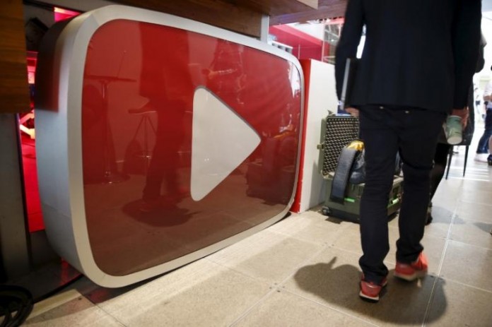 A man walks past a YouTube logo at the YouTube Space LA in Playa Del Rey, Los Angeles