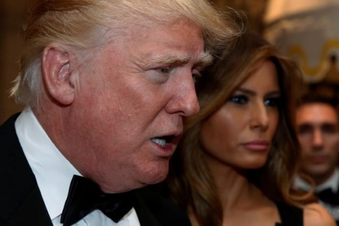 U.S. President-elect Donald Trump talks to reporters as he and his wife Melania Trump arrive for a New Year's Eve celebration with members and guests at the Mar-a-lago Club in Palm Beach