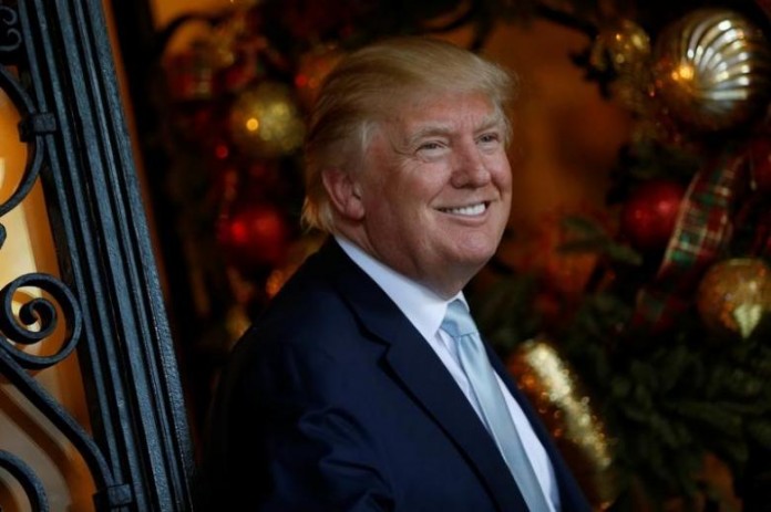 Trump speaks briefly to reporters between meetings at the Mar-a-lago Club in Palm Beach, Florida
