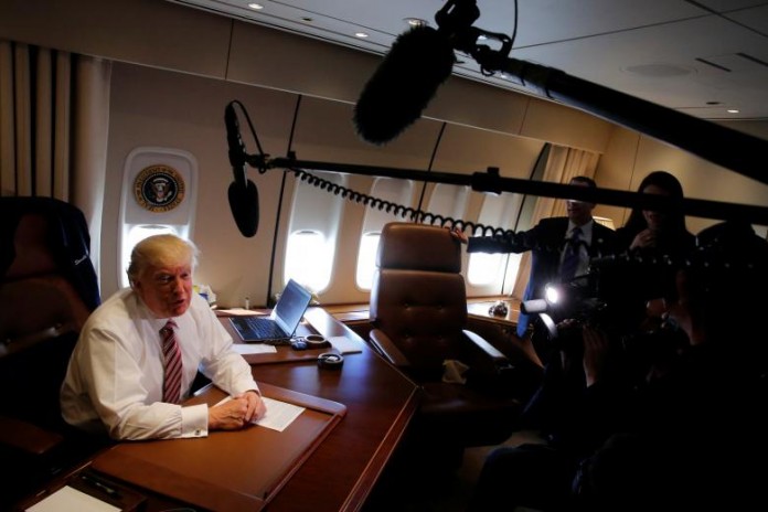 Trump speaks briefly to reporters as he arrives aboard Air Force One at Joint Base Andrews
