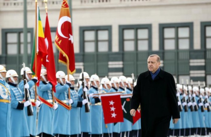 Turkish President Erdogan reviews a guard of honour during a welcoming ceremony at the Presidential Palace in Ankara
