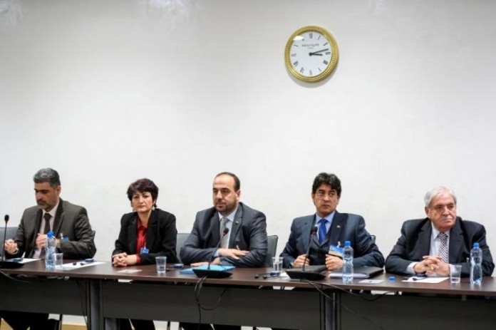 Syria's main opposition delegation with High Negotiations Committee (HNC) leader Nasr al-Hariri (C) attend a meeting with United Nations (UN) Syria envoy during Syria peace in Geneva.