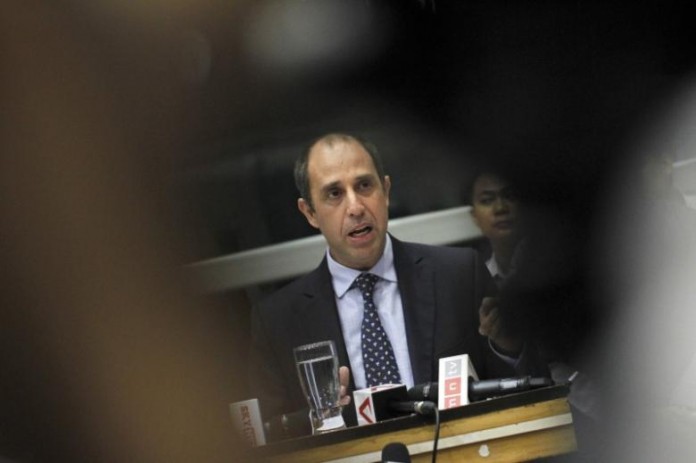 Tomas Ojea Quintana, U.N. special envoy on human rights in Myanmar, reads his statement at a news conference in Yangon International Airport