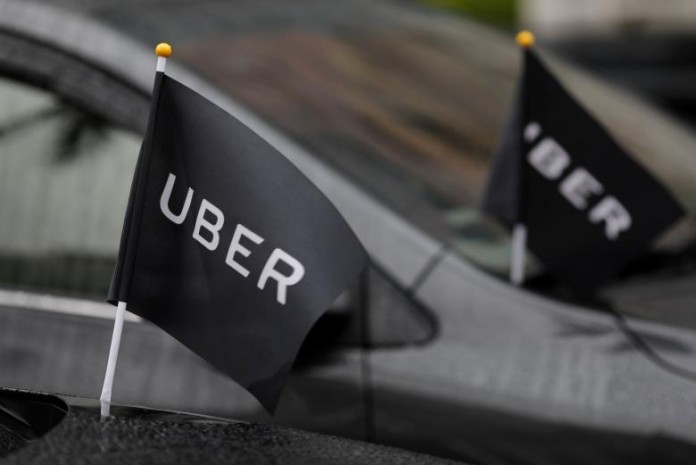 Uber drivers' cars are parked outside the Ministry of Transportation building during a protest in Taipei
