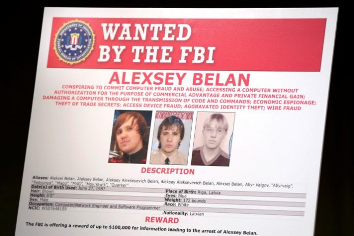 A poster of suspected Russian hackers is seen before FBI National Security Division and the U.S. Attorney's Office for the Northern District of California joint news conference at the Justice Department in Washington