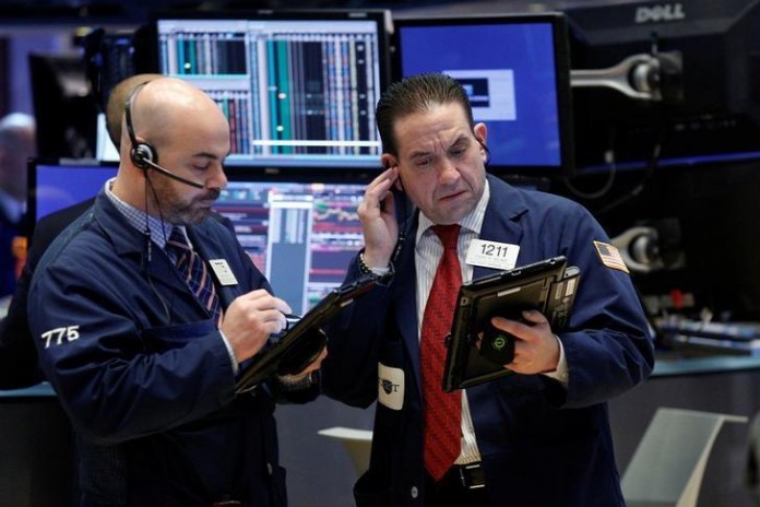 Traders work on the floor of the NYSE