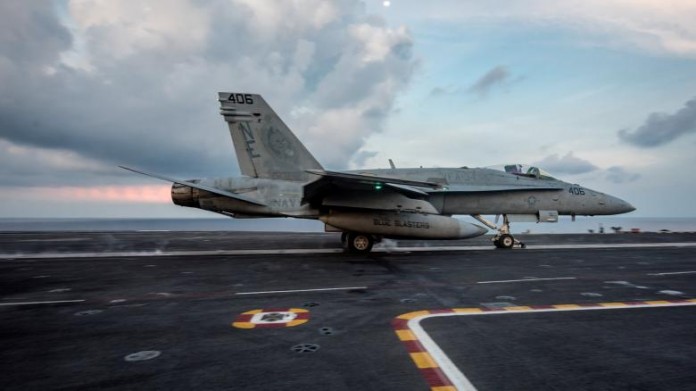 An F/A-18C Hornet launches from the aircraft carrier USS Carl Vinson