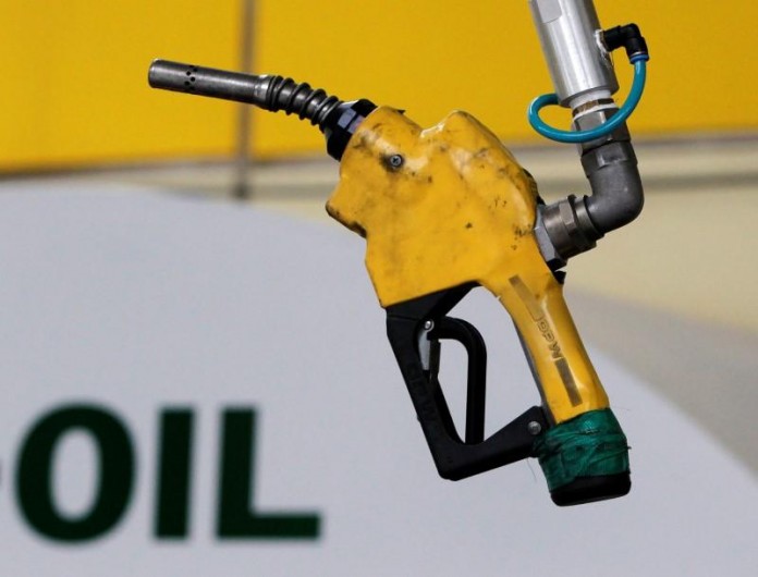 FILE PHOTO - A gas pump is seen hanging from the ceiling at a petrol station in Seoul