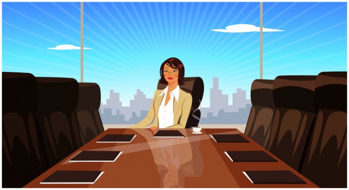 Businesswoman sitting at conference table in boardroom
