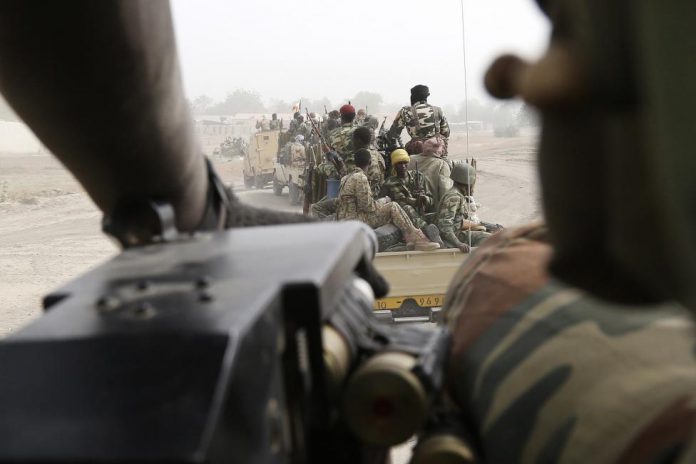 Chadian soldiers drive near the front line during battle against insurgent group Boko Haram in Gambaru