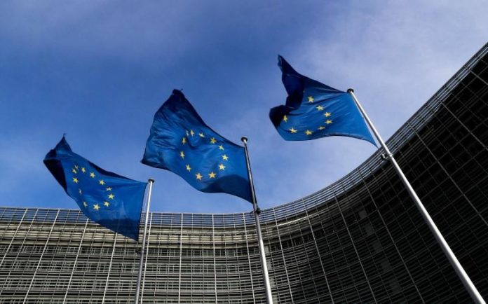 European Union flags flutter outside the EU Commission headquarters in Brussels