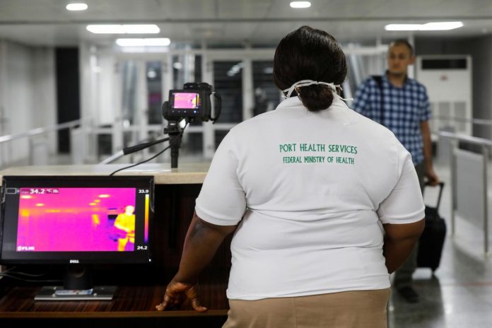 A Nigerian health services official screens visitors inside one of the airports.