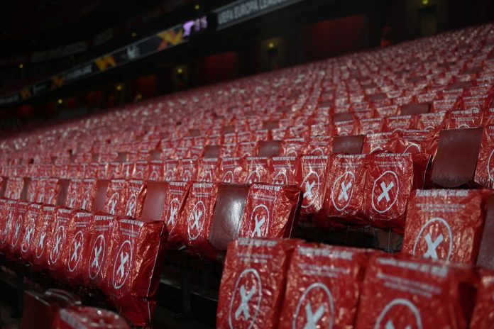 UK stadium seats covered with covid-19 do not sit tag