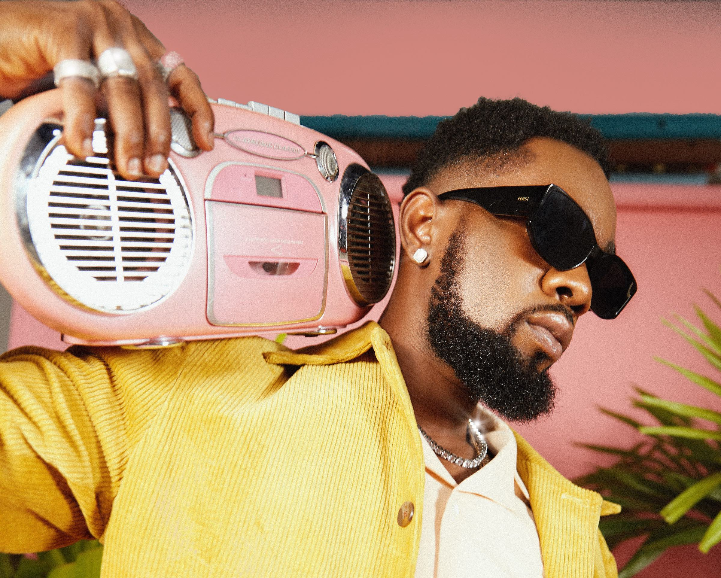 patoranking - THEWILL NEWS MEDIA Patoranking with radio on his shoulder