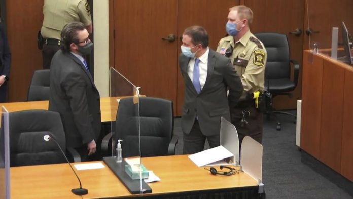 former Minneapolis police Officer Derek Chauvin is taken into custody as his attorney, Eric Nelson, left, looks on, after the verdicts were read at Chauvin's trial for