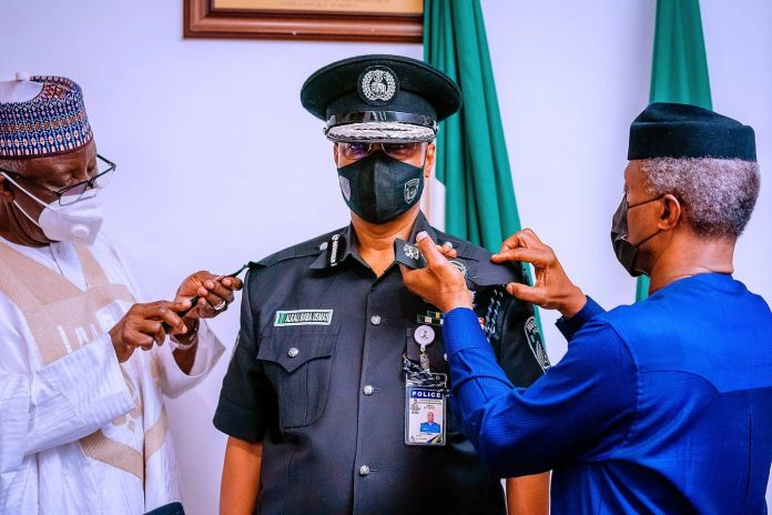 Vice President Yemi Osinbajo SAN decorates the new Acting Inspector General of The Nigeria Police Force Usman Alkali Baba at the State House, Abuja Vice President Yemi Osinbajo SAN decorates the new Acting Inspector General of The Nigeria Police Force Usman Alkali Baba at the State House, Abuja