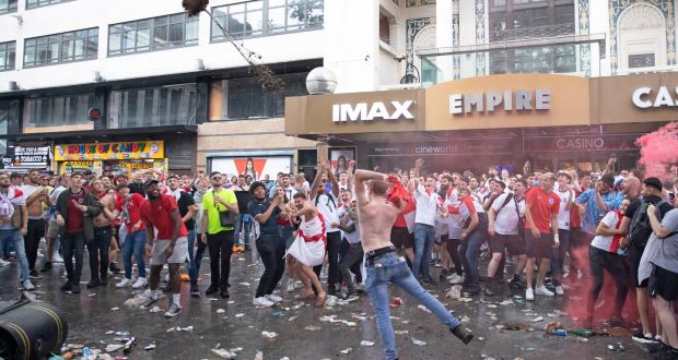 England supporters throw a tree as they gather in Leicester Square