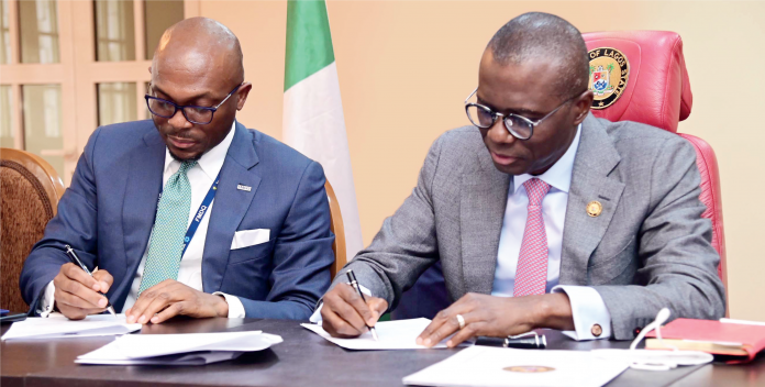 R-L: Lagos State Governor Babajide Sanwo-Olu and Chief Executive Officer, FMDQ Group, Mr. Bola Onadele Koko, at the MoU signing ceremony between the Lagos State Government and the Nigerian Green Bond Market Development Programme, held in Lagos on 14/9/2021. Photo: Peace Udugba.