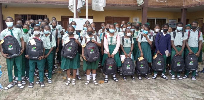 Students of Kuramo Senior College, Victoria Island, Lagos in a group photograph with educational materials donated by the National Engineering and Technical Company (NETCO) on Wednesday.