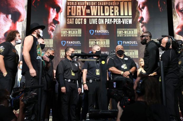 Tyson Fury And Deontay Wilder Weigh Tyson Fury And Deontay Wilder Weigh