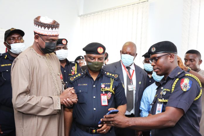 A Fire Service officer demonstrates with a mobile phone how the Fire Alert System can be notified at the inauguration of State House Fire Alert Centre.