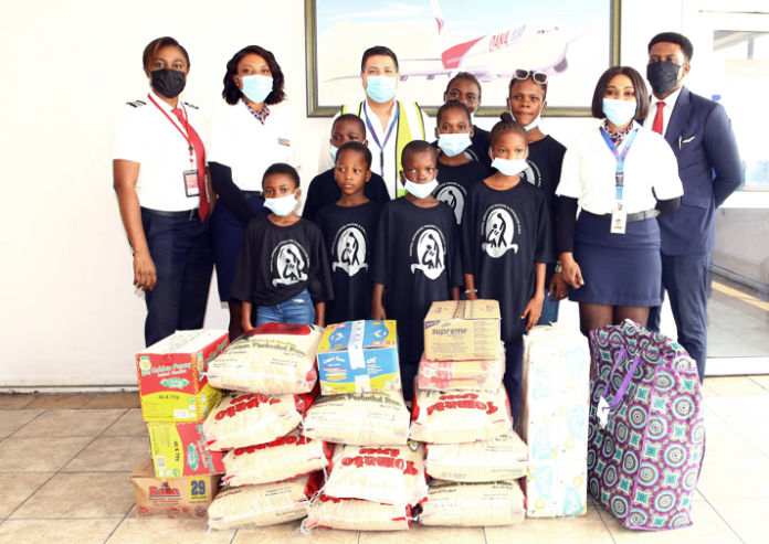 L-R: Ngozi Idigbe Dana Air's First Officer, Amaka Uchibuolu cabin crew, Sukhjinder Mann Deputy CEO of Dana Air, Juliet Martins Purser, Nonso Ibe, during Dana Air's CSR donations to Favid Orphanage home and V.O.W (Hope) orphanage in Lagos recently.