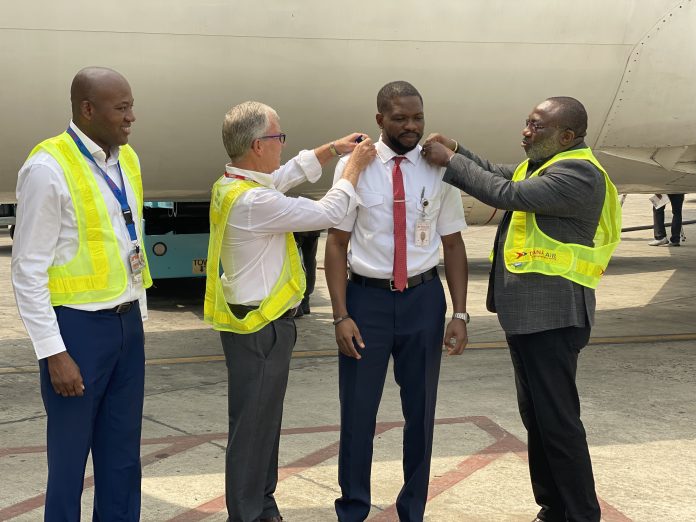L-R Dana Air's Accountable Manager, Obi Mbanuzuo, Chief Pilot Captain John Hazel, newly decorated B737 Captain Andrew Igbe-Arase, and Director of Flight Operations, Captain Segun Omole during the decoration of captain Andrew Igbe-Arase as a captain on Dana Air's Boeing 737 aircraft in Lagos recently. 