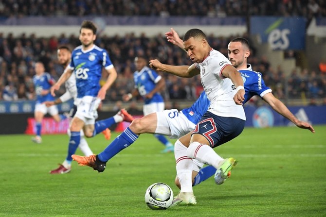 FBL-FRA-LIGUE1-STRASBOURG-PSG Paris Saint-Germain's French forward Kylian Mbappe up against Strasbourg's French defender Lucas Perrin during their French L1 football match between at La Meinau stadium in Strasbourg, eastern France, on April 29, 2022. (AFP)