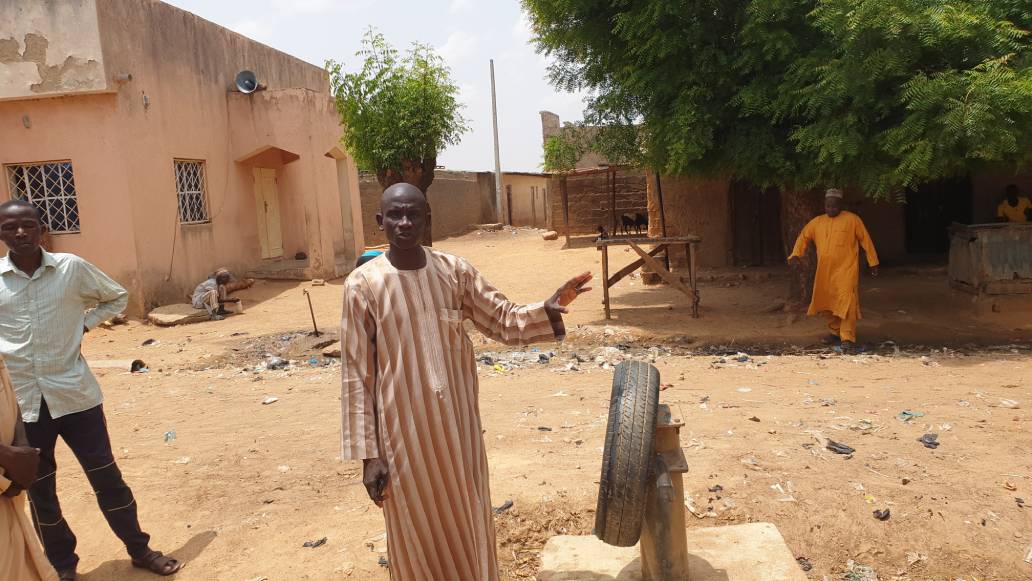 A resident standing beside a non functioning borehole (1) - THEWILL NEWS MEDIA A resident standing beside a non functioning borehole