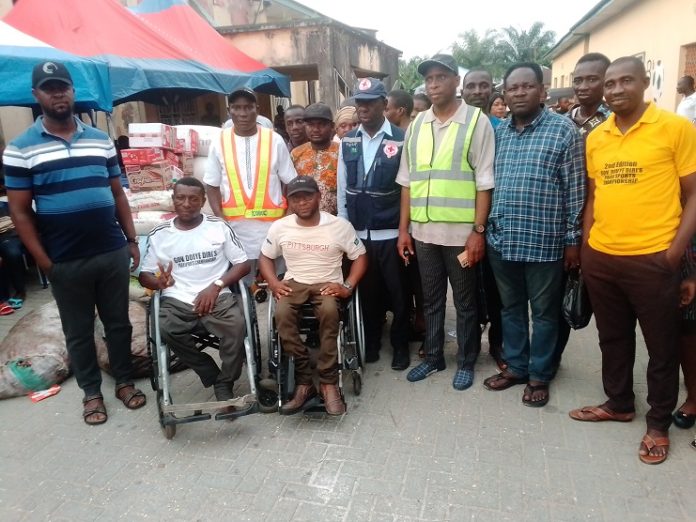 Disabled persons in a group photograph with Task Force Committee on Flood Management and Mitigation.