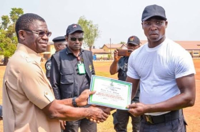 Edo Deputy Governor, Philip Shaibu, presenting a certificate to one of the graduands