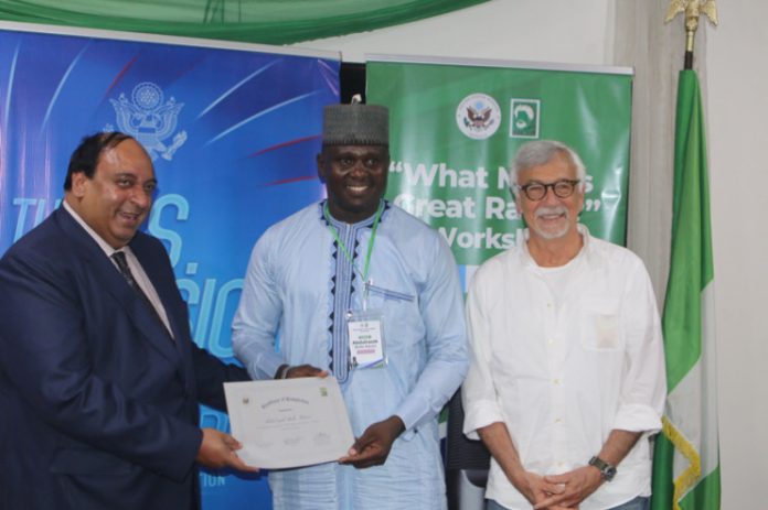 L-R; U.S. Embassy Counselor for Public Affairs, Adnan Siddiqi; a participant, Abdulrazak Bello Kaura of Pride FM Zamfara, with Workshop Trainer, Professor Steven Reiner (right), at the closing ceremony in Abuja.