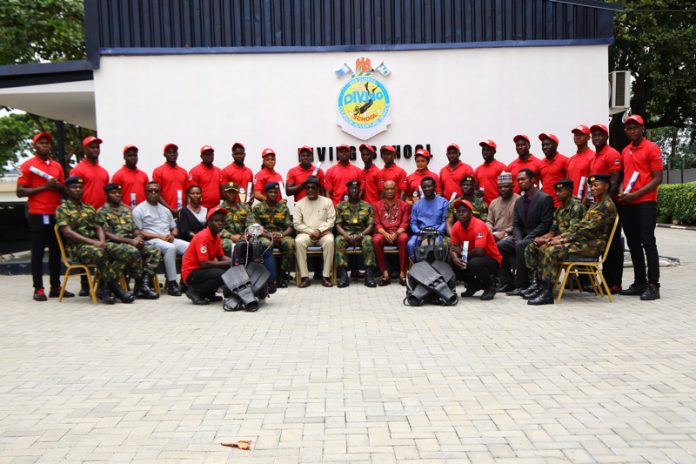Executive Secretary, Nigerian Content Development and Monitoring Board (NCDMB), Engr. Simbi Kesiye Wabote; Commandant, Naval Training Command, Lagos, Quorra, Cmdr. Adamu Yahaya; senior officials of the NCDMB and Mieka Dive Training Institute (MDTI) with graduates of the commercial air dive training programme organised by the Board at the Nigerian Navy Underwater Warfare School, Navy Town, Ojo, Lagos State. Executive Secretary, Nigerian Content Development and Monitoring Board (NCDMB), Engr. Simbi Kesiye Wabote; Commandant, Naval Training Command, Lagos, Quorra, Cmdr. Adamu Yahaya; senior officials of the NCDMB and Mieka Dive Training Institute (MDTI) with graduates of the commercial air dive training programme organised by the Board at the Nigerian Navy Underwater Warfare School, Navy Town, Ojo, Lagos State.