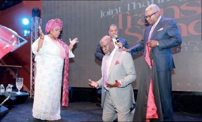 Olaoye surrounded by wife, pastors in a send-forth anointing service