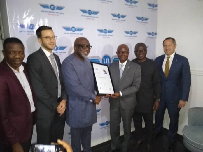Prof. Obiora Okonkwo, Chairman, United Nigeria Airlines (3rd left), receiving IATA's membership certificate from Regional Director IATA, Dr. Samson Fatokun (3rd right); Chief Operating Officer (COO) of the airline, Mazi Osita Okonkwo (2nd right) and representatives from Airbus at the airline’s office in Lagos on Thursday.