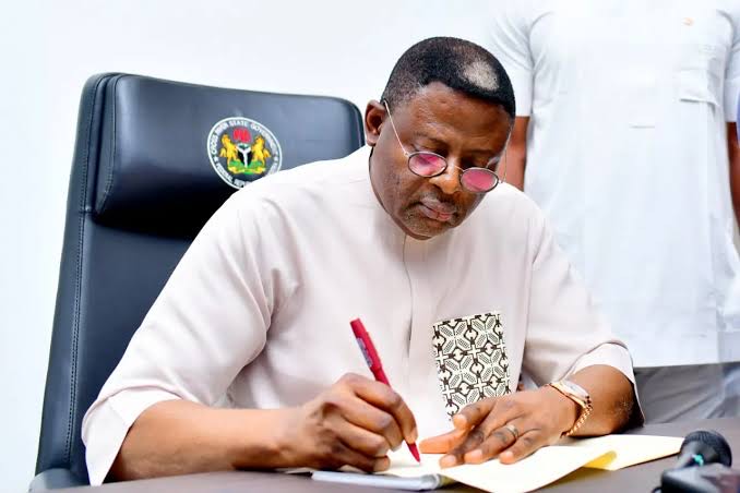 Senator Bassey Otu signs