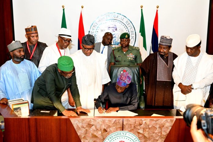 Tinubu Signs Tinubu Signs